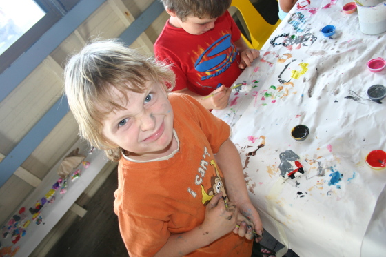 A 'Happy' Smirk from a young boy during Plaster Painting